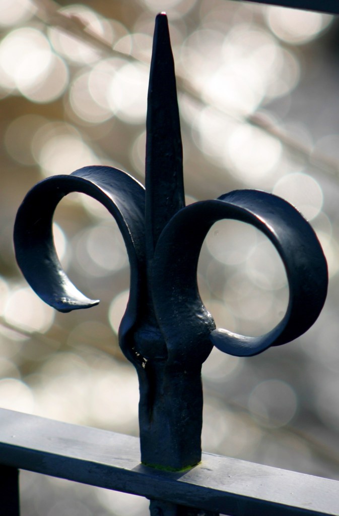 Fleur-de-lis scroll.